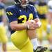 Michigan sophomore place kicker Brendan Gibbons stretches during warm ups at practice on Tuesday.  Melanie Maxwell I AnnArbor.com
